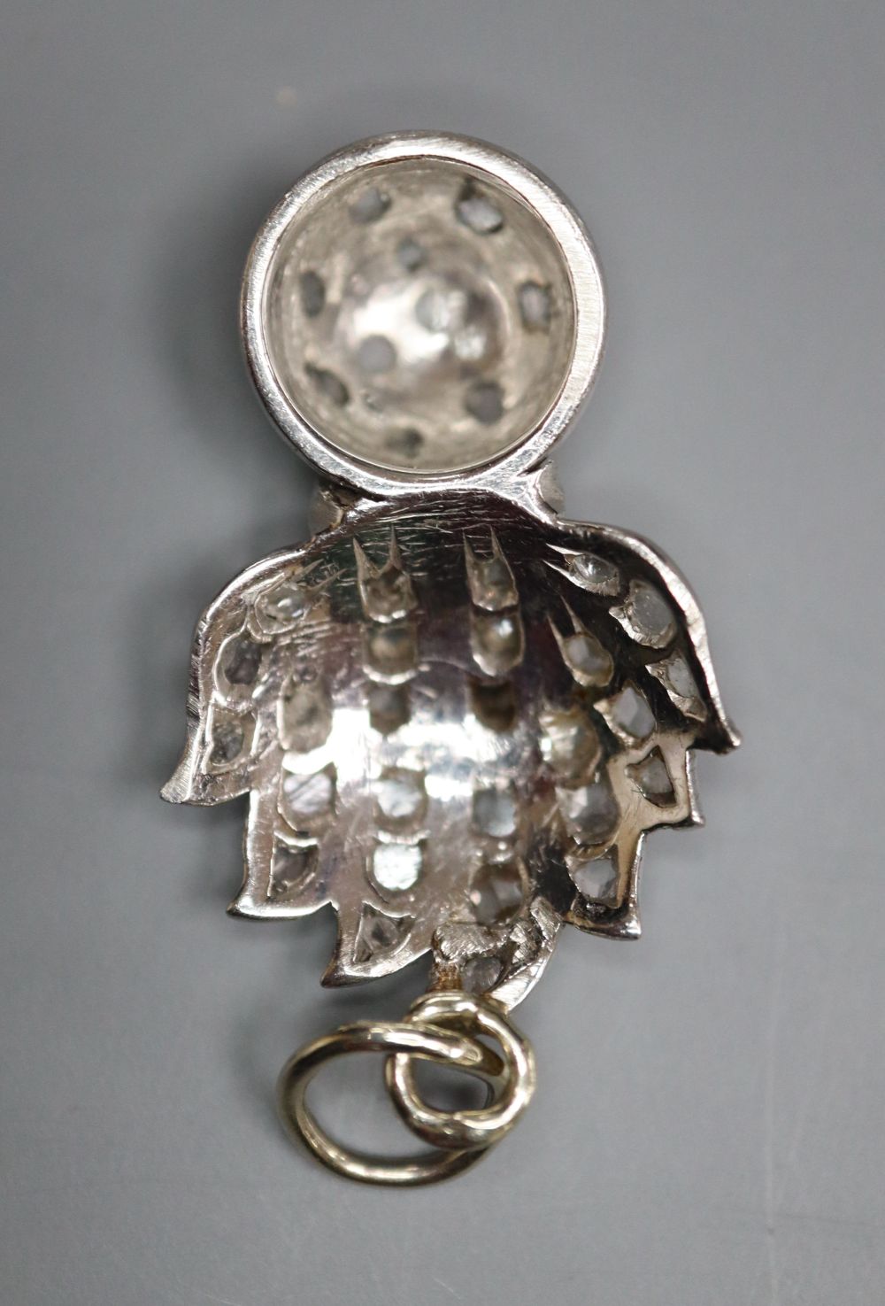 An early 20th century white metal and rose cut diamond set Royal Fusiliers pendant, 26mm, gross 4.7 grams.